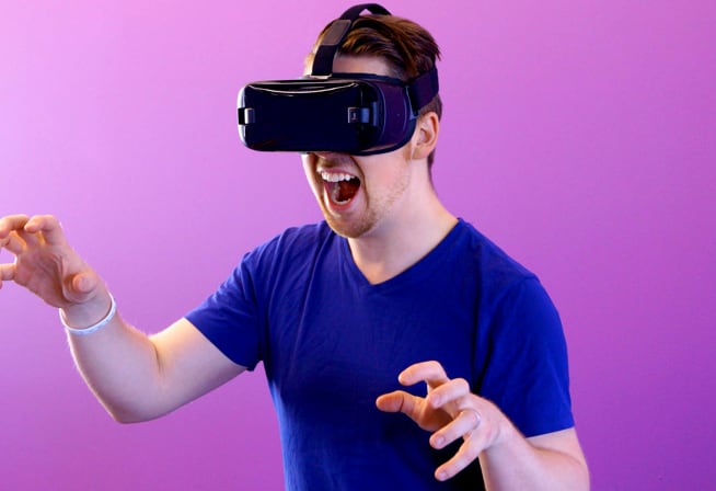 An excited person wearing VR goggles